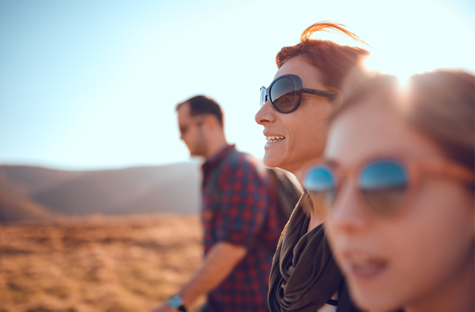 a family hikes through the foothills while wearing polarized sunglasses